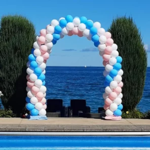 Smalll spiral balloon arch with pink and blue balloons weaved together