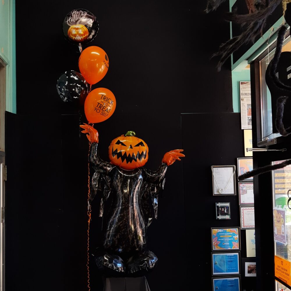 Pumpkin head character balloon with bouquet